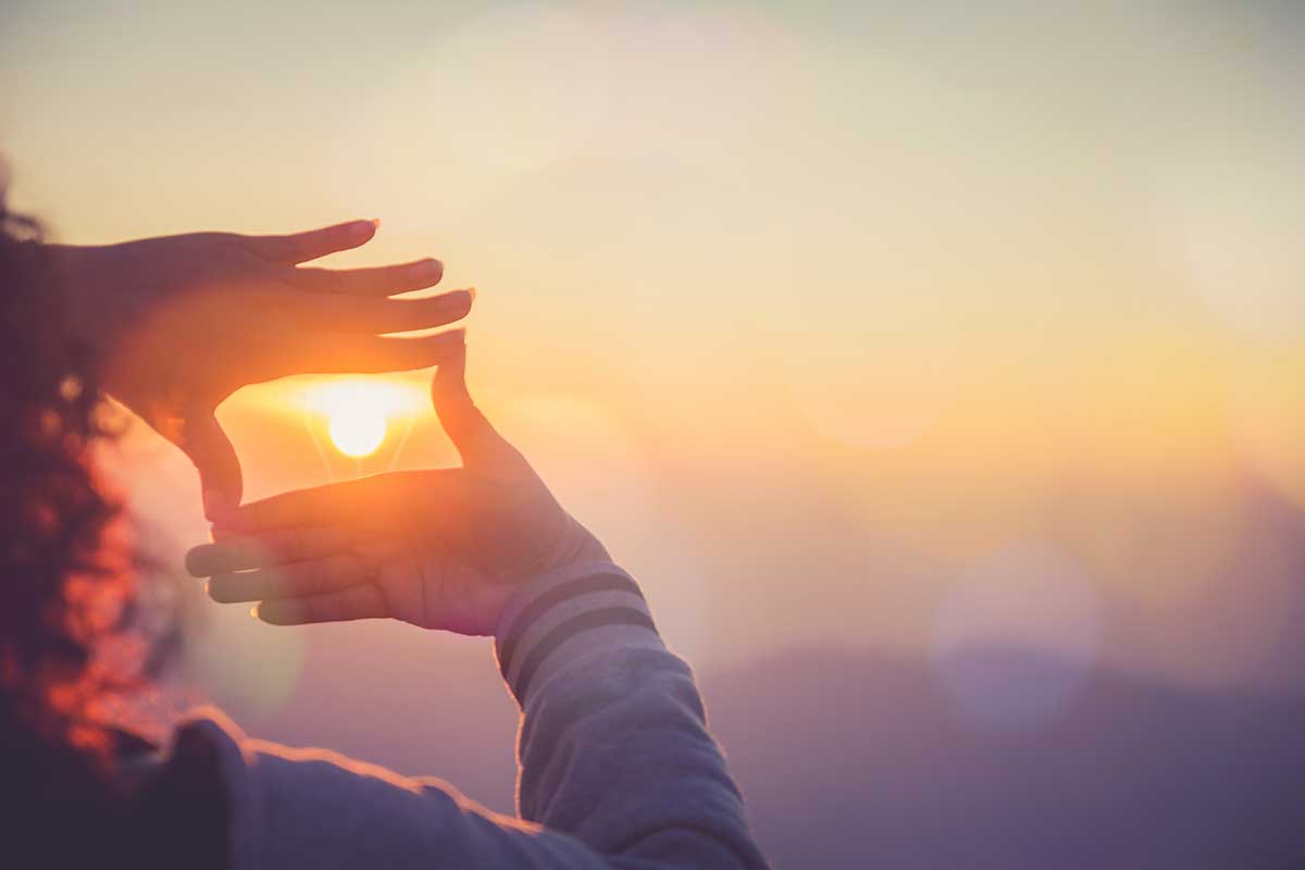 Hands framing sunset