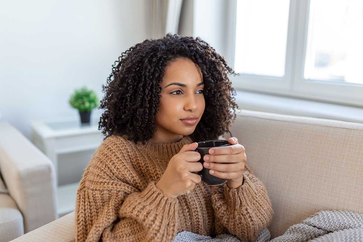 Woman drinking hot beverage